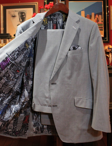 Light grey suit with a city skyline print lining