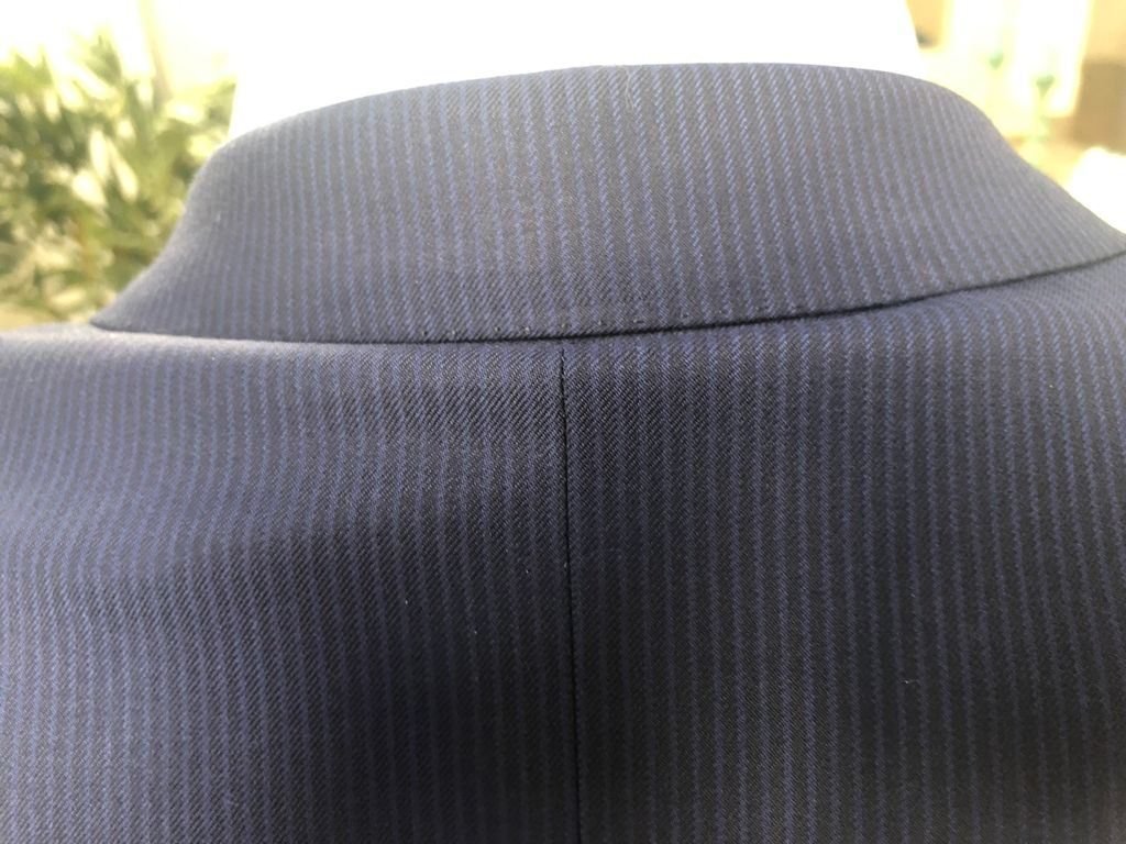 Back of the collar on a finished navy pinstripe suit jacket