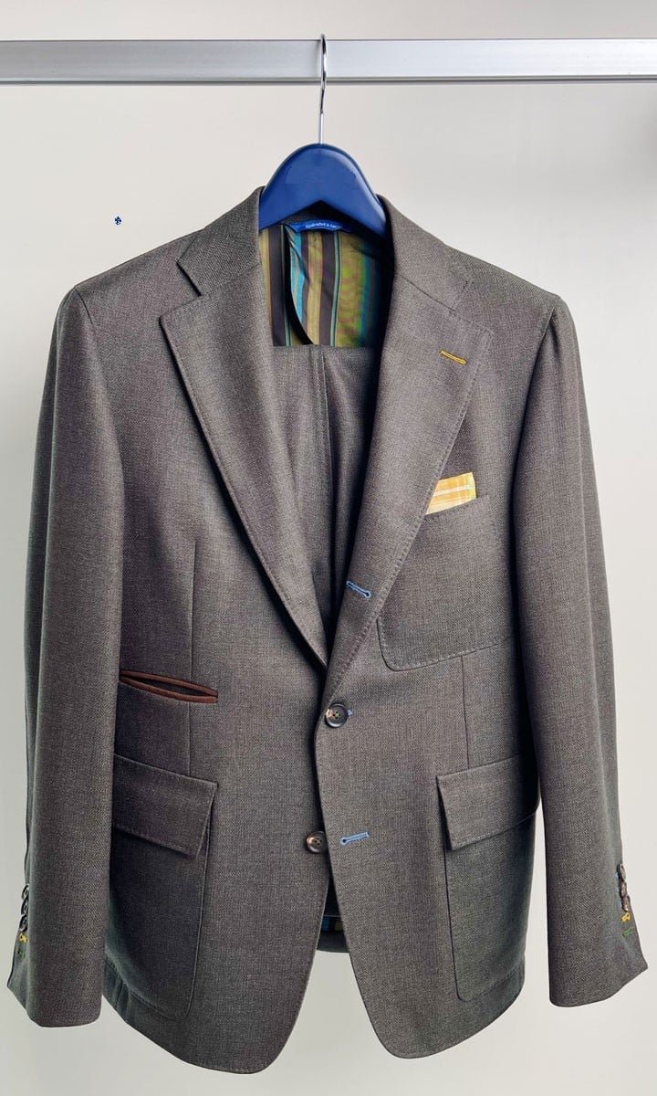 Taupe two-button suit, contrast buttonholes