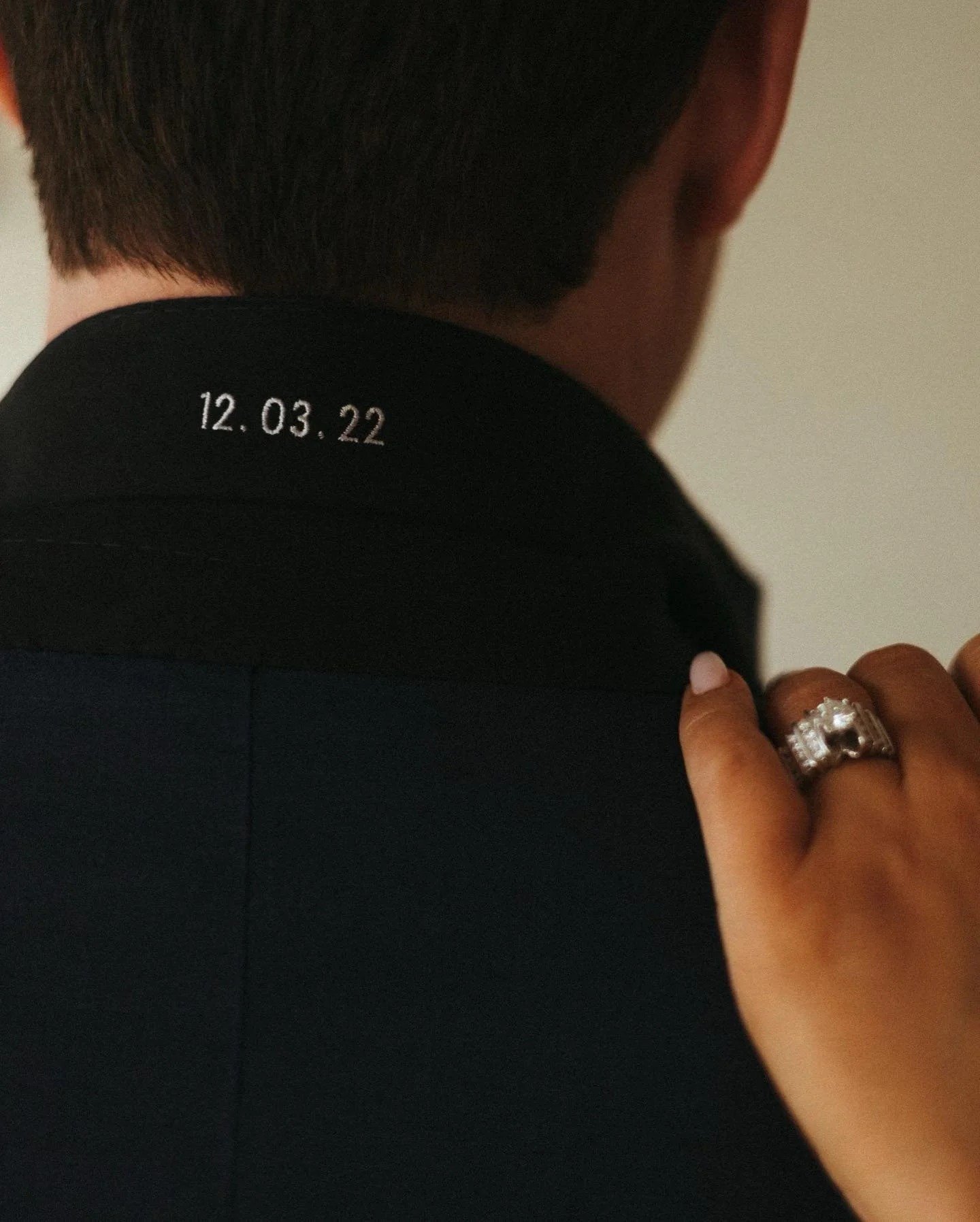 Wedding date embroidered under the collar of a custom suit